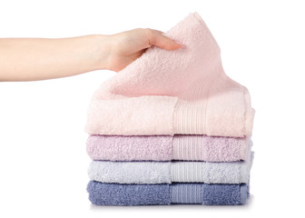 Fototapeta na wymiar A stack of towels pink blue in hand