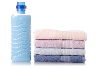 Obraz na płótnie Canvas A stack of towels softener conditioner liquid laundry detergent