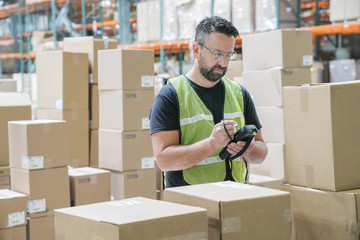 Warehouse worker using hand held scanner