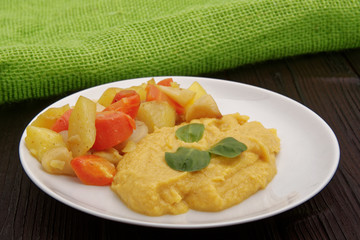 Roasted vegetables and hummus on a table