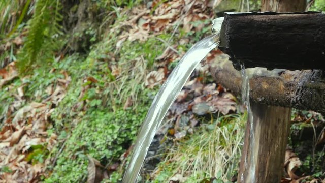 Man washes his hands in a mountain spring