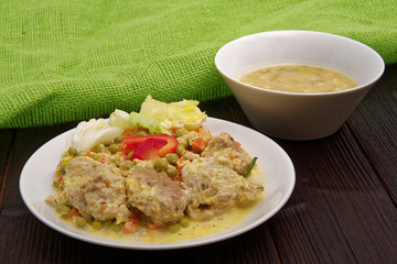 Stewed vegetables with oatmeal dumplings on a table