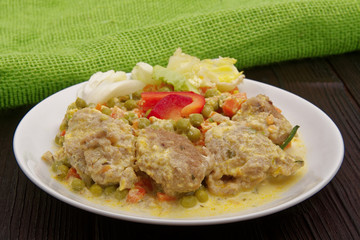 Stewed vegetables with oatmeal dumplings on a table