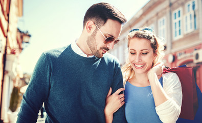 Fototapeta premium Shopping time. Young couple in shopping. Consumerism, love, dating, lifestyle concept
