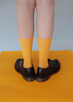 Legs of woman in bright yellow socks
