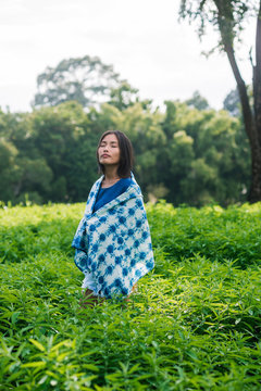 Asian woman wearing Shibori natural indigo clothes