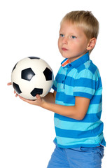 Little boy is playing with a soccer ball.