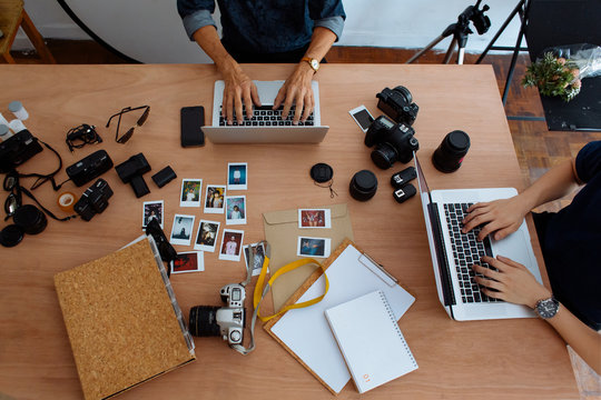 Photographers working on computer at the office