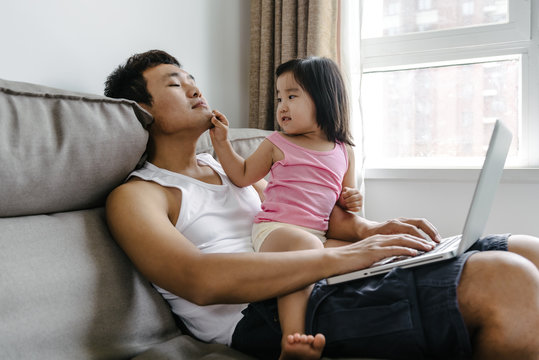 Adorable girl and her father at home