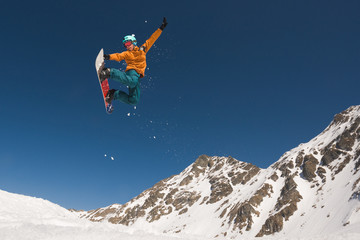 Man with snowboard performing extreme midair tricks
