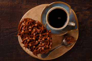 Chocolate egg with filling for Easter on wooden background