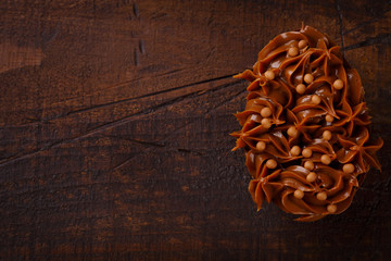 Chocolate egg with filling for Easter on wooden background