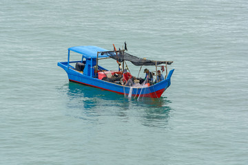 Naklejka na ściany i meble Fishermen in motor boat