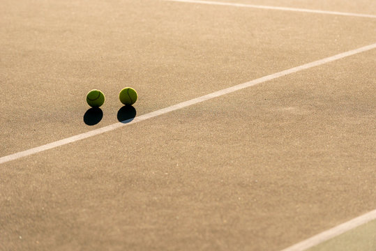 Tennis balls on empty tennis court