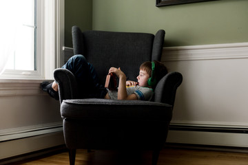 little boy on electronic device / tablet