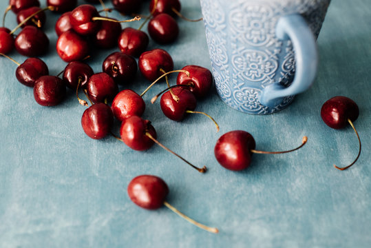 Cherries and a patterned mug