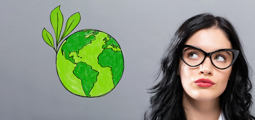 Green Earth with young businesswoman in a thoughtful face
