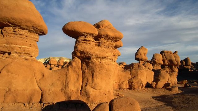 Sunlight glowing on the Hoodoos in Goblin Valley while walking through them at sunset.