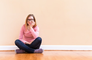 Young woman thinking about something in a big room