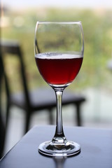 Red wine glass on wooden table