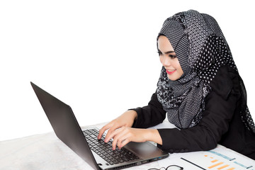 Beautiful modern asian muslim business woman looking at computer,isolated on white background.