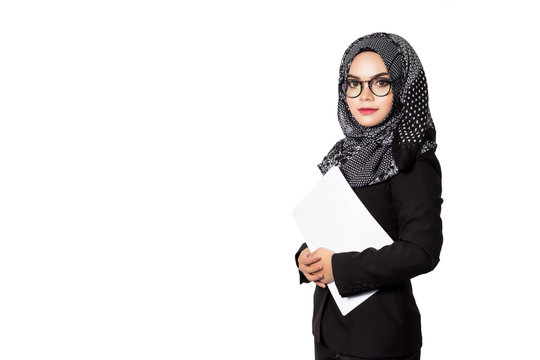 Beautiful modern Asian Muslim business woman holding reports and looking at camera,isolated on white background.