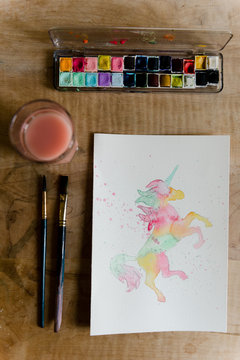 teen painting a Unicorn in watercolour