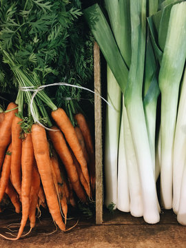 Detail Of Fresh Carrots And Leeks In A Wooden Crate For Sale. UK