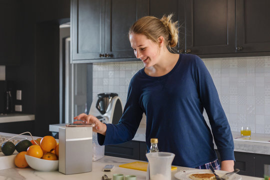 teenager making breakfast and enjoying music