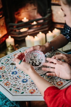 Woman fortune teller reading tea leaves