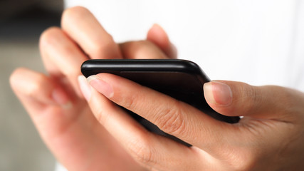 Closeup business woman hand using smartphone for connecting internet, communication technology concept background
