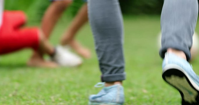 Children running after soccer ball. Kids playing football in 4K