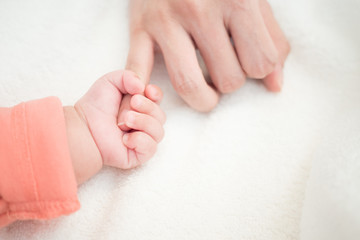 New Born Baby hand hold little finger of mom: concept of love, take care, parent relationship