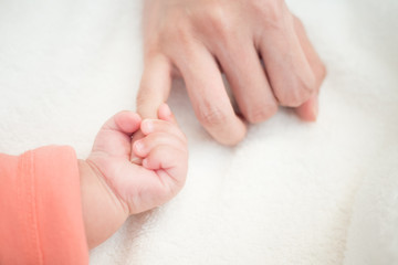 New Born Baby hand hold little finger of mom: concept of love, take care, parent relationship
