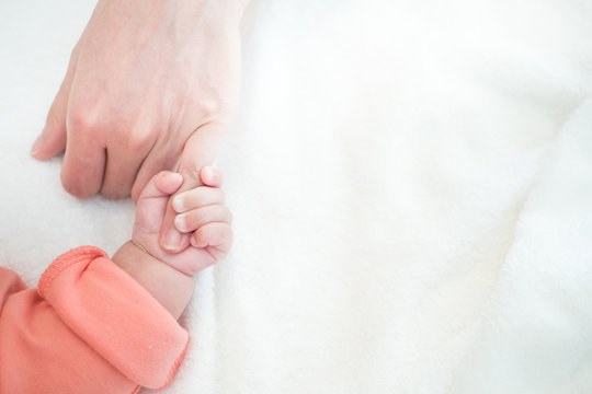 New Born Baby hand hold little finger of mom: concept of love, take care, parent relationship