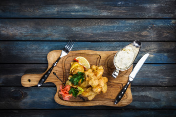 Fish and Chips with sauce tartar served with cutlery