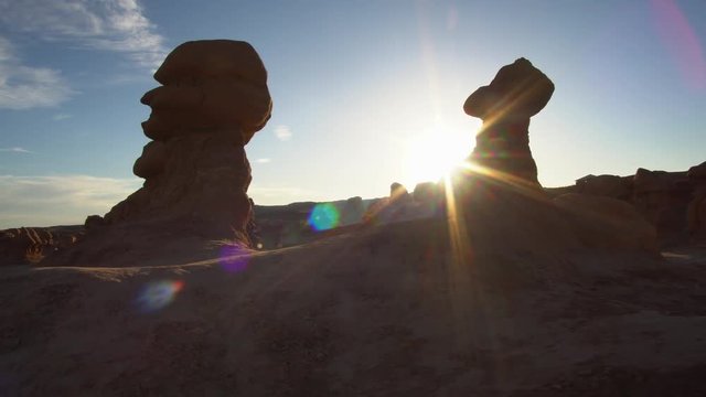 Rays of sunlight beaming through the hoodoos in Goblin Valley while walking through them in the evening.