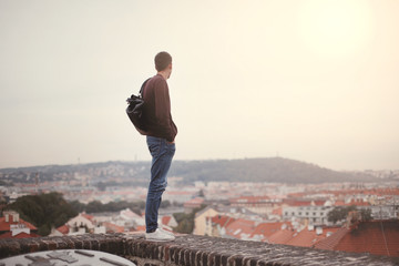 Lonely men are looking city view and sunset