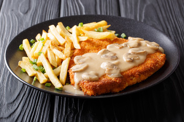 Crispy Fried Pork Chops (Jaeger Schnitzel) with sauce and french fries close-up. Horizontal