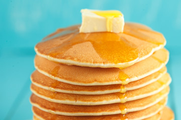 Stack of pancake with honey and butter on top