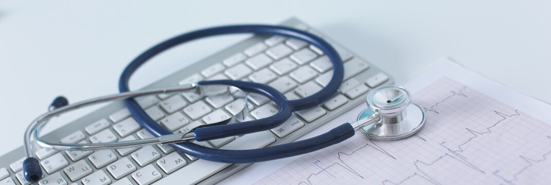 Stethoscope on cardiogram concept for heart care on the desk.blue toned images
