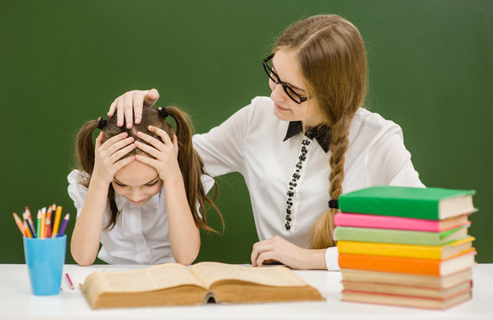 the teacher comforts the sad girl