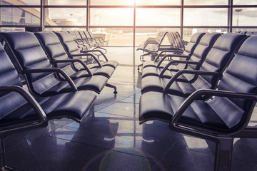 Seats in the airport waiting room at sunset. No one is sitting in the airport.