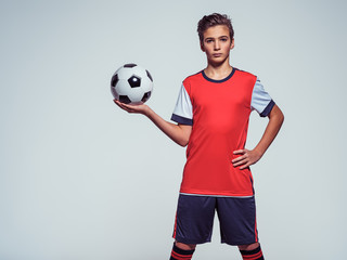 Photo of teen boy in sportswear holding soccer ball © Valua Vitaly