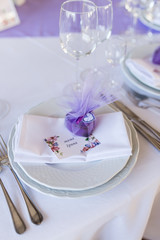 A wedding purple bonbonniere in a shape of heart lying on a white plate