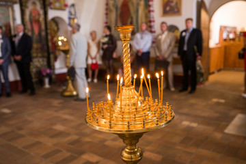 Burning wax candles in a candlestick in the Orthodox  church.