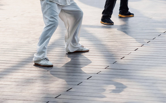 Chinese Taiji style, the legs and shadows on ground, Kungfu concept.