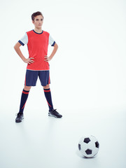 Fototapeta na wymiar Photo of teen boy in sportswear holding soccer ball