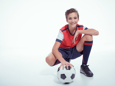 Smiling Teen Boy In Sportswear Holding Soccer Ball