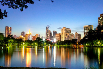 Skyscraper view from Lumpini park in the evening, Bangkok,Thailand